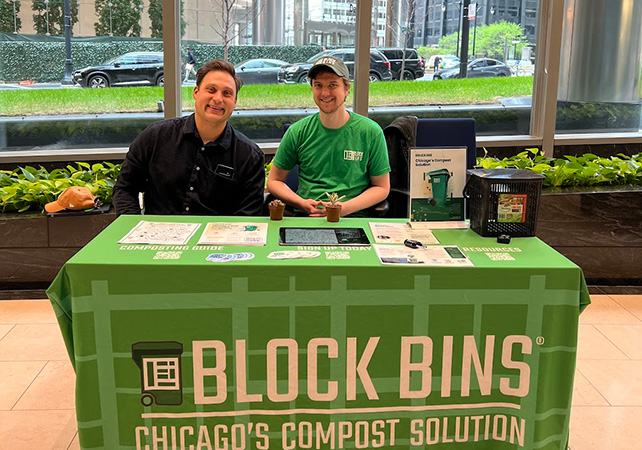 Block Bins employees at a Block Bins table with informational materials